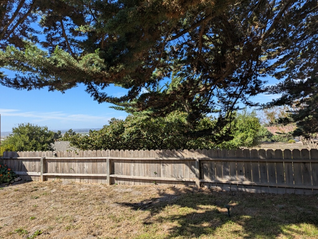 backyard showing fence and view overlooking hill